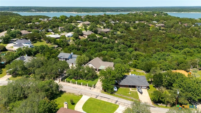 bird's eye view of a nearby body of water and a heavily wooded area