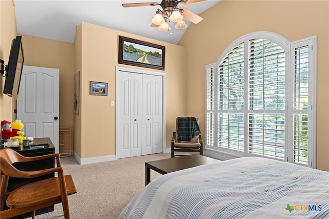 bedroom featuring carpet, lofted ceiling, a closet, baseboards, and ceiling fan
