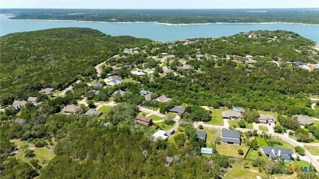 aerial view of property's location with a large body of water, a heavily wooded area, and nearby suburban area