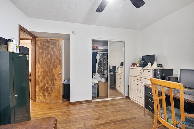 home office featuring wood finished floors and a ceiling fan