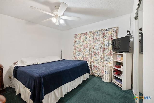 bedroom with dark colored carpet and a ceiling fan