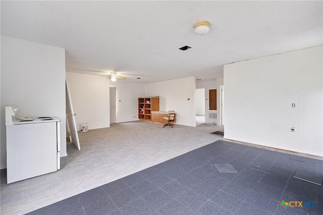 living area with a ceiling fan and washer / clothes dryer