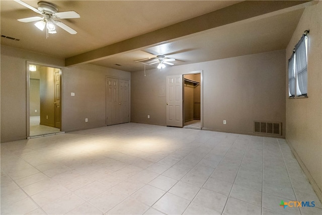 spare room with ceiling fan and beam ceiling