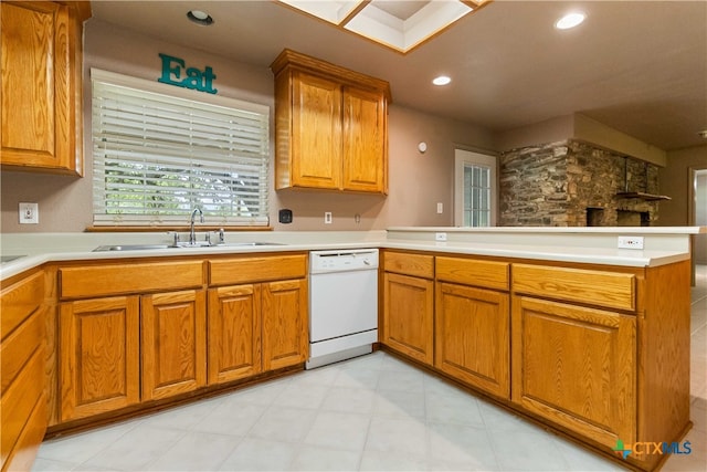 kitchen featuring kitchen peninsula, sink, and white dishwasher