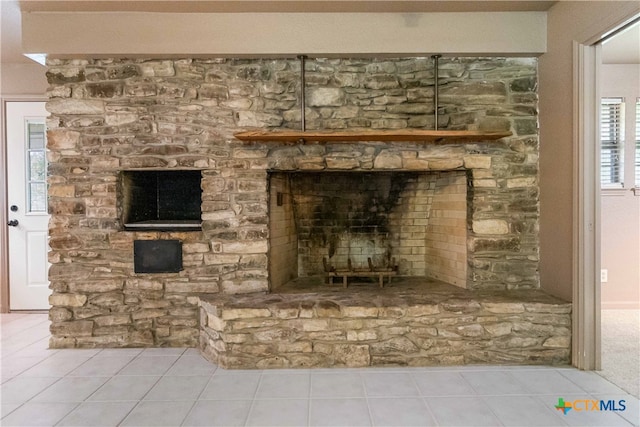 details featuring a fireplace and tile patterned floors