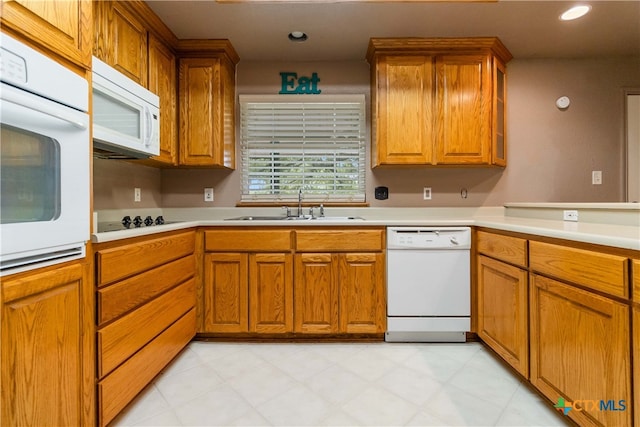 kitchen featuring white appliances and sink