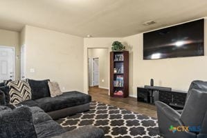 living room with dark hardwood / wood-style floors