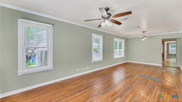 1261 W Mill St, New Braunfels, TX 78130 - empty room featuring hardwood / wood-style floors, crown molding, ceiling fan, and a textured ceiling