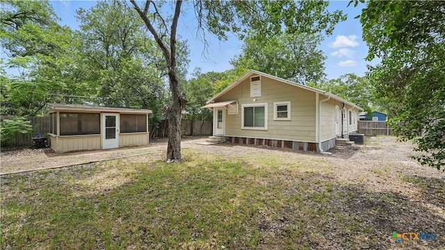 1261 W Mill St, New Braunfels, TX 78130 - back of house featuring a sunroom, a fenced backyard, and entry steps