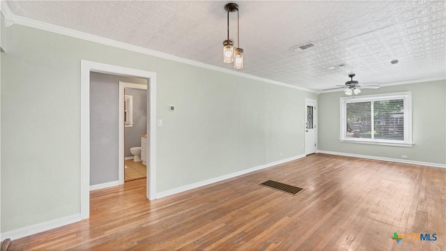 1261 W Mill St, New Braunfels, TX 78130 - empty room featuring wood-type flooring, ceiling fan, and ornamental molding