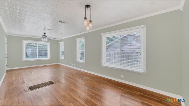 1261 W Mill St, New Braunfels, TX 78130 - unfurnished room featuring crown molding, wood finished floors, plenty of natural light, and ceiling fan