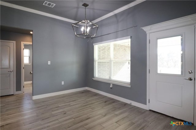 entrance foyer with baseboards, wood finished floors, visible vents, and a healthy amount of sunlight