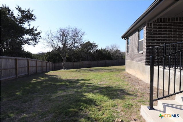 view of yard with a fenced backyard