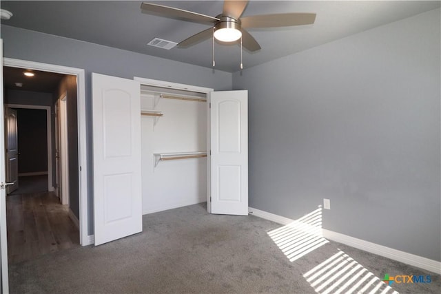 unfurnished bedroom with a closet, carpet, visible vents, and baseboards