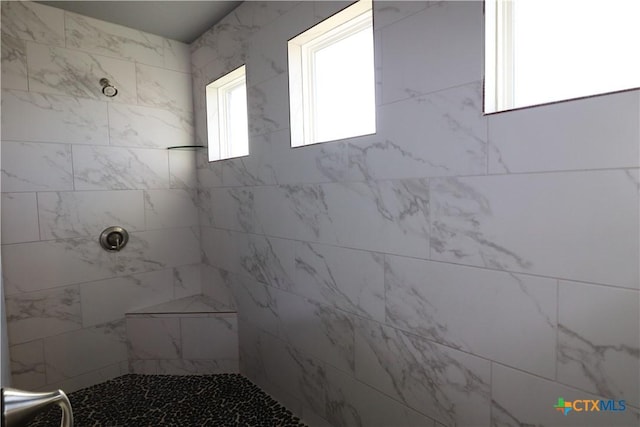 bathroom featuring tiled shower