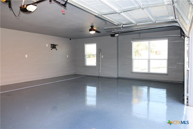 garage with a garage door opener and baseboards