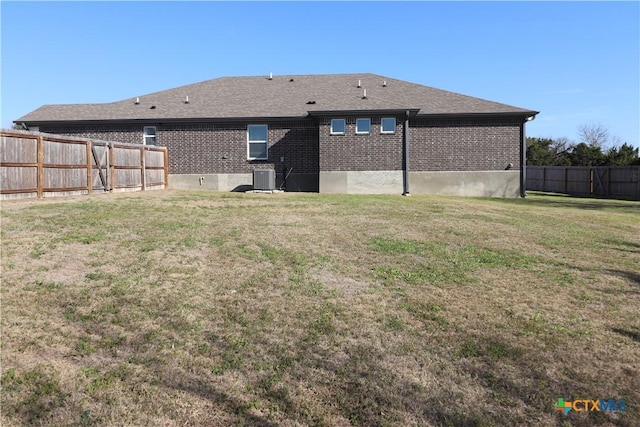 view of yard with fence and central AC