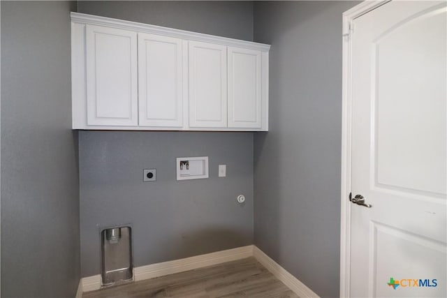 laundry room featuring cabinet space, baseboards, wood finished floors, hookup for a washing machine, and electric dryer hookup