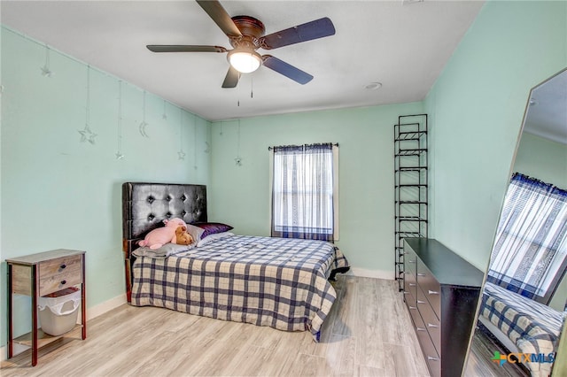 bedroom with light wood-type flooring and ceiling fan