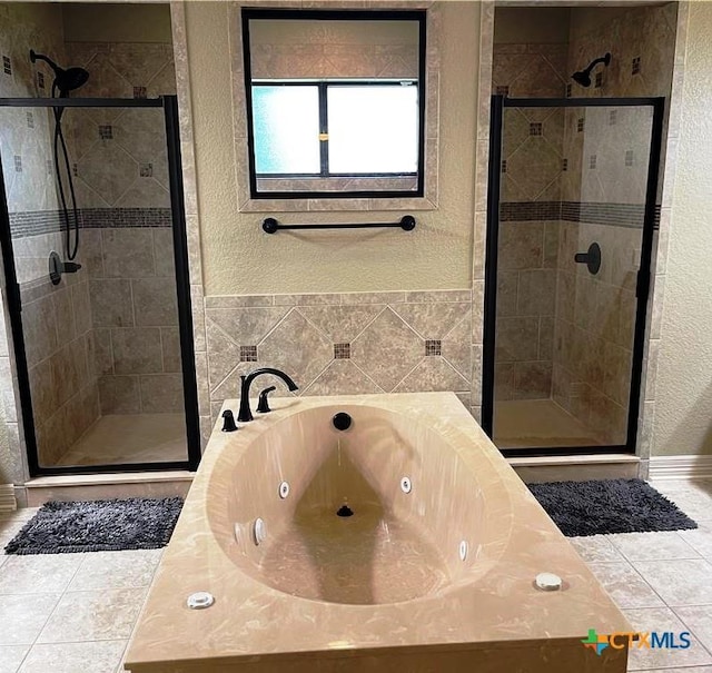 full bathroom featuring tile patterned flooring, a tub with jets, and a stall shower