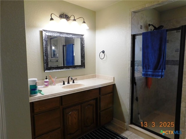 full bathroom with a stall shower and vanity