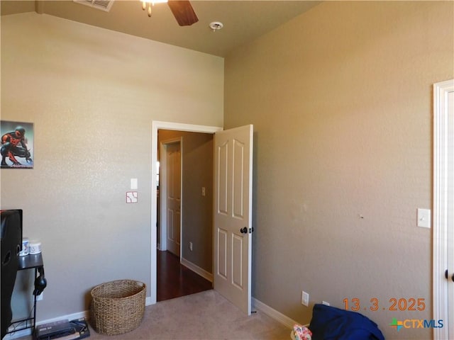 carpeted bedroom with visible vents, a ceiling fan, and baseboards