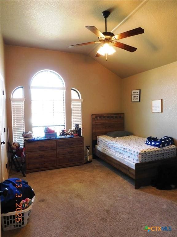 bedroom featuring carpet flooring, ceiling fan, a textured ceiling, and lofted ceiling