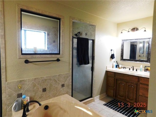 bathroom with vanity, a garden tub, tile patterned flooring, and a shower stall