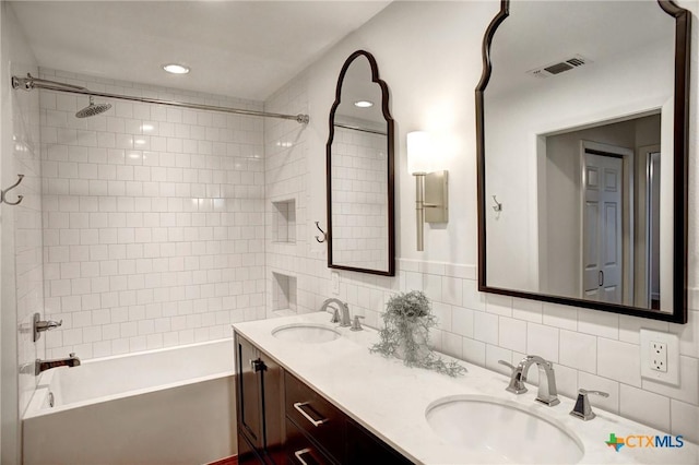 416 S Welhausen Ave, Shiner, TX 77984 - bathroom with washtub / shower combination, double vanity, and decorative backsplash