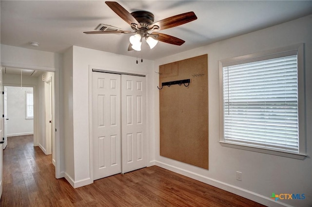 416 S Welhausen Ave, Shiner, TX 77984 - unfurnished bedroom with attic access, baseboards, wood finished floors, and a closet
