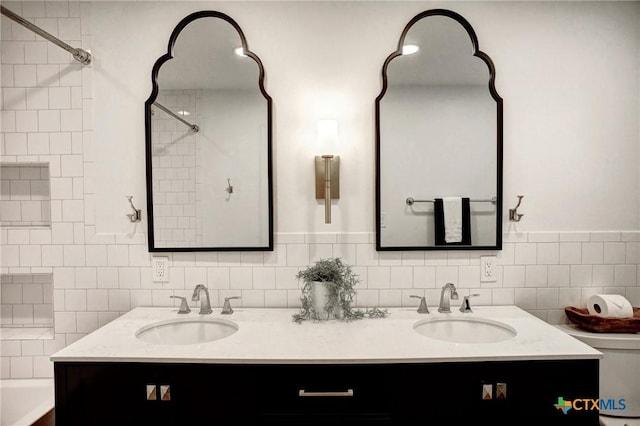 416 S Welhausen Ave, Shiner, TX 77984 - full bath featuring double vanity, a shower, a tub to relax in, tile walls, and toilet