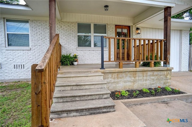 416 S Welhausen Ave, Shiner, TX 77984 - doorway to property with a porch and brick siding