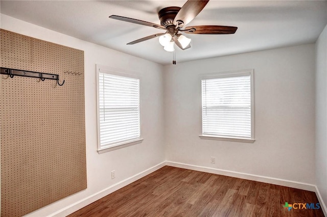 416 S Welhausen Ave, Shiner, TX 77984 - unfurnished bedroom featuring baseboards, wood finished floors, and ceiling fan