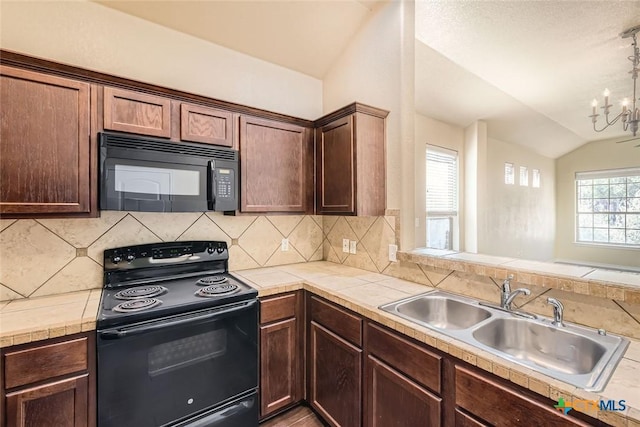 kitchen with vaulted ceiling, black appliances, sink, an inviting chandelier, and backsplash