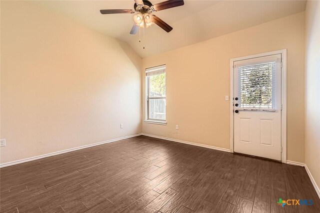 interior space featuring ceiling fan, vaulted ceiling, and dark hardwood / wood-style floors