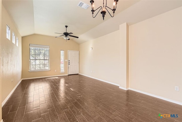 spare room with ceiling fan with notable chandelier and lofted ceiling