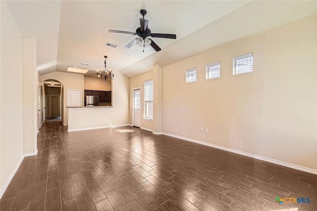 unfurnished living room featuring ceiling fan with notable chandelier and vaulted ceiling