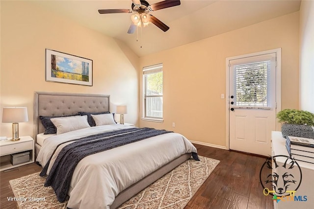 bedroom featuring ceiling fan, dark hardwood / wood-style flooring, and lofted ceiling