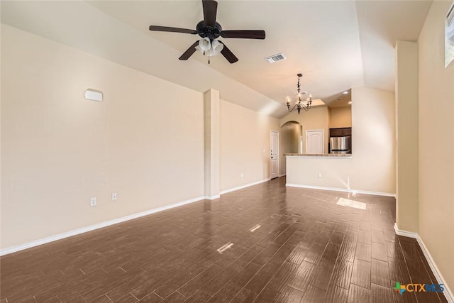 unfurnished living room with ceiling fan with notable chandelier and lofted ceiling