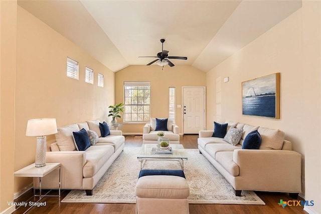 living room featuring dark wood-type flooring, ceiling fan, and vaulted ceiling