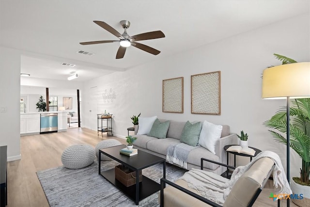 living room with ceiling fan and light hardwood / wood-style floors