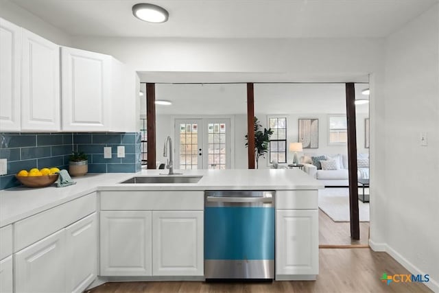 kitchen with white cabinetry, dishwasher, sink, and french doors