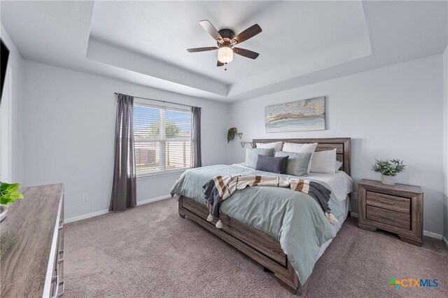 2215 Bellmont, Temple, TX 76504 - carpeted bedroom featuring a tray ceiling, baseboards, and a ceiling fan