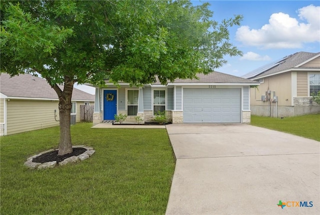2215 Bellmont, Temple, TX 76504 - view of front of house with an attached garage, stone siding, driveway, and a front lawn