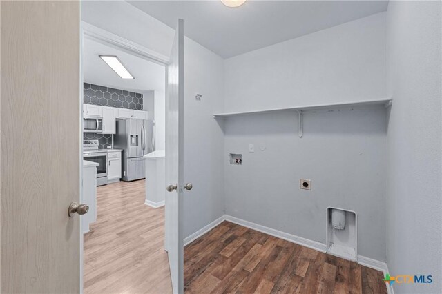 2215 Bellmont, Temple, TX 76504 - laundry room with hookup for a washing machine, light wood-style flooring, electric dryer hookup, and hookup for a gas dryer