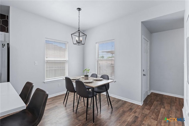 2215 Bellmont, Temple, TX 76504 - dining area with dark wood-type flooring, a chandelier, and baseboards