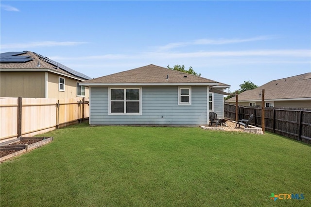 2215 Bellmont, Temple, TX 76504 - back of house with a vegetable garden and a shingled roof