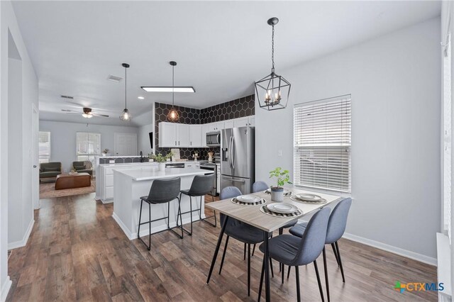 2215 Bellmont, Temple, TX 76504 - dining space featuring dark wood-type flooring, a chandelier, baseboards, and ceiling fan