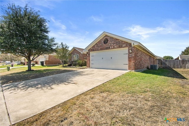 view of front facade featuring a front lawn, a garage, and central AC unit