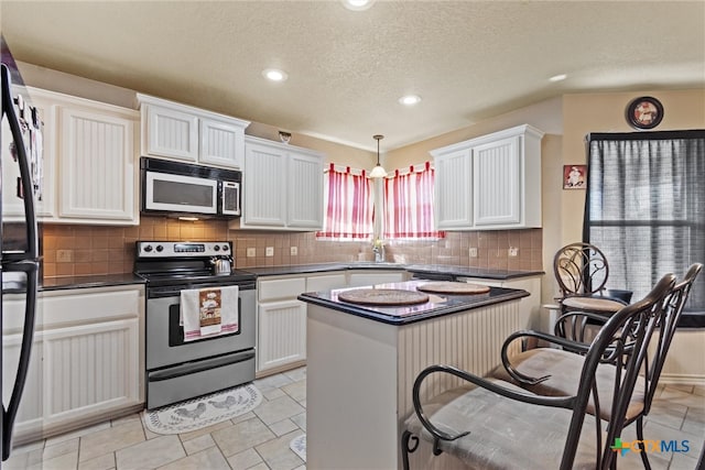 kitchen featuring white cabinetry, appliances with stainless steel finishes, and a healthy amount of sunlight